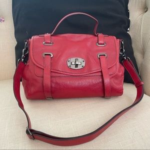 Leather handbag in red. Can be worn as a shoulder, top handle, or crossbody bag.